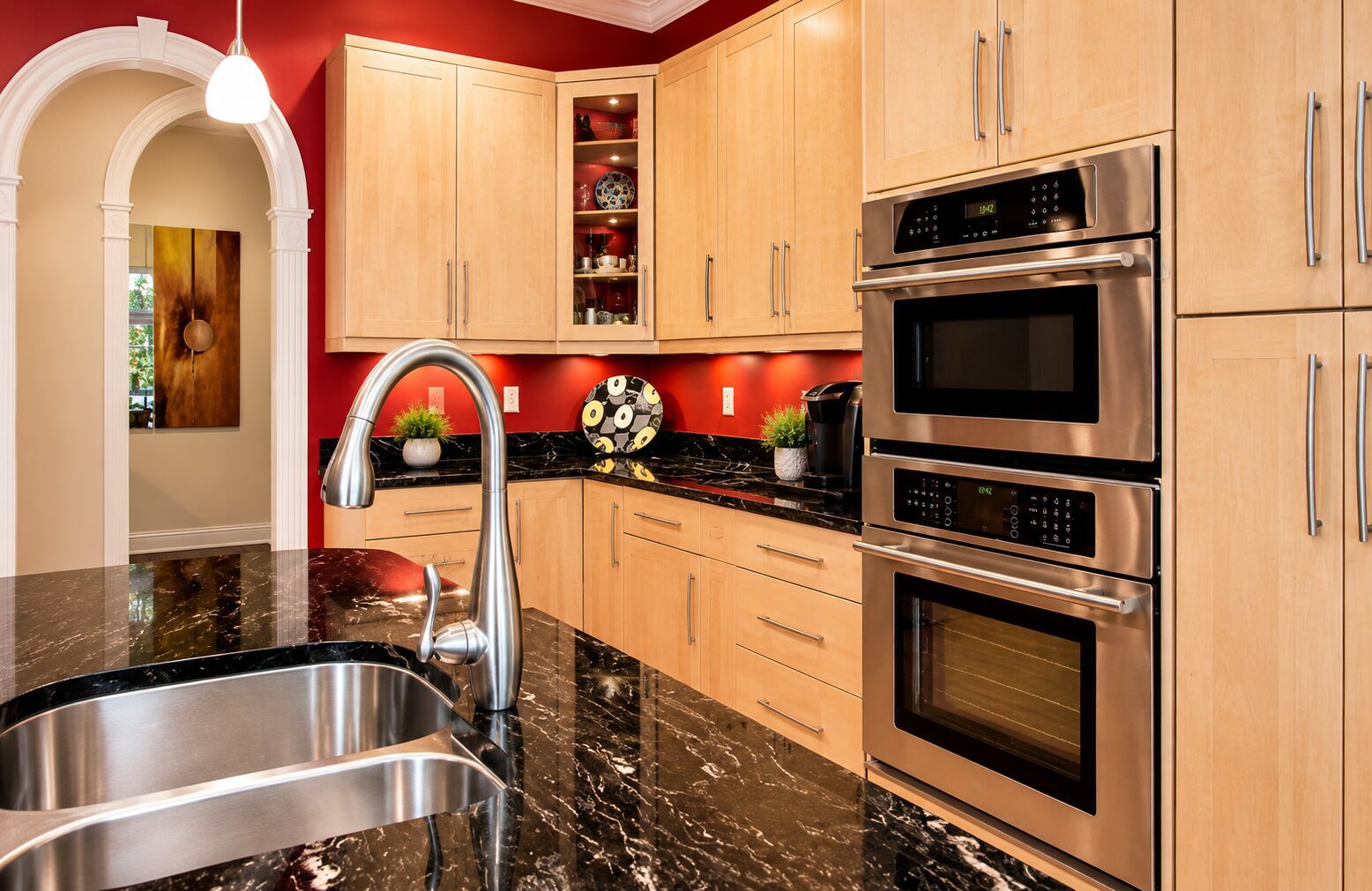 Light-wood kitchen with black granite countertops