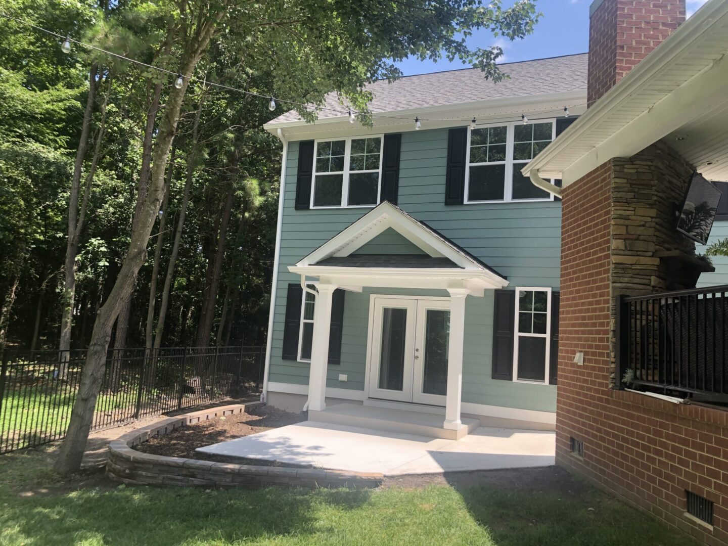 Blue two-story house with white columned porch