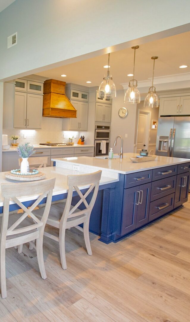Modern kitchen with blue island and pendant lights